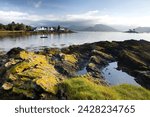 Early morning view of plokton with houses and foreshore bathed in sunlight, plokton, near kyle of lochalsh, highland, scotland, united kingdom, europe