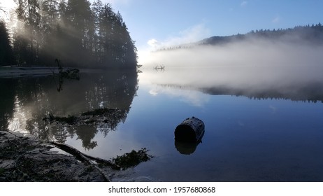 Early Morning View Of Rays Of Sunshine Over Foggy Sasamat Lake. Taken From White Pine Beach In Port Moody, BC