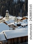 An early morning view of snow covered rooftops in san cassiano near the alta badia ski area, dolomites, south tyrol, italy, europe