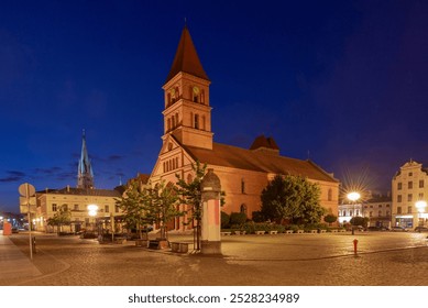 Early morning view of St. Catherine's Church on the market square illuminated by street lamps, Torun, Poland - Powered by Shutterstock