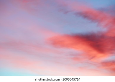 An early morning winter sunrise image of a cloudy sky, no planes, blues, reds, yellows