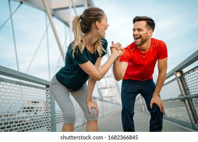 Early Morning Workout. Happy Couple Running Across The Bridge