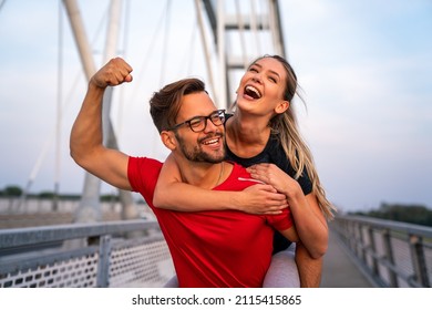 Early morning workout. Happy couple running across the bridge. Living healthy lifestyle. - Powered by Shutterstock