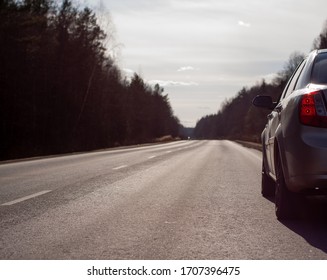 Early Spring. Car On An Asphalt Road In The Forest