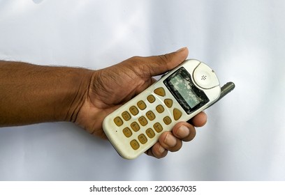 Early Stages Old Vintage Mobile Phone, Antenna Cellular Phone, Cell Phone, Cellphone, Handphone Or Pocket Portable Telephone Isolated In Hand On White Background