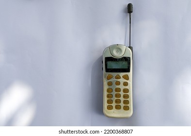 Early Stages Old Vintage Mobile Phone, Antenna Cellular Phone, Cell Phone, Cellphone, Handphone Or Pocket Portable Telephone Isolated On White Horizontal Background.