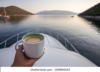 Early summer morning with cup of coffee cappuccino on a yacht in the Antisamos bay, Kefalonia island, Ionian sea, Greece.