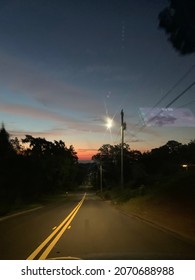 Early Sunrise Photo While Driving Down A Dark Road