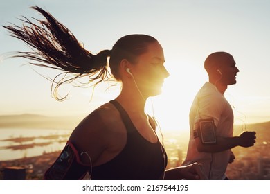 Up Early For Their Morning Jog. Shot Of A Young Couple Exercising Outdoors.