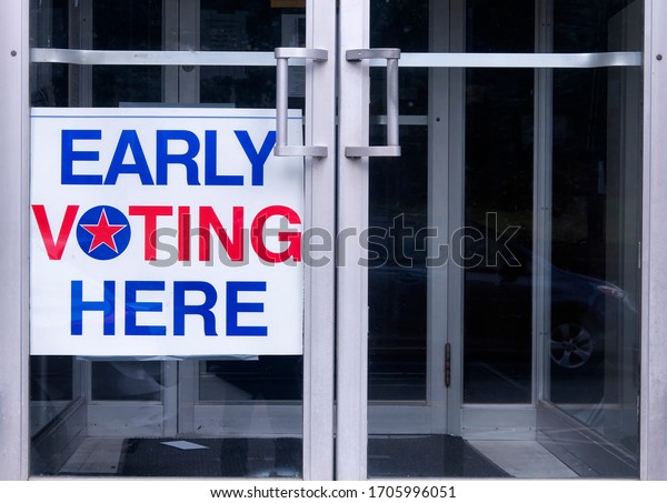 An\
early voting sign on a door welcoming people to vote for an\
democratic election in the united states of america. \
