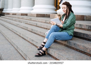 Earn extra money, Side hustle, money making, Gig economy, hustling, digital nomad. Side Jobs to Make Some Extra Money. Young woman, student with tattoo and dreadlocks working outside