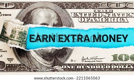 Earn extra money text written on with American Dollar-bills. Text Earn extra money on dollar usa background. Concept of financial planning Make more extra money from parttime side hustle or second job