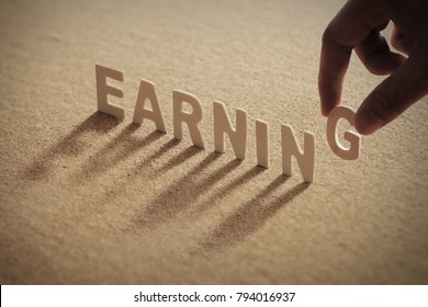 Earning Wood Word On Compressed Corkboard Stock Photo (Edit Now) 794016937