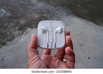 Earphones In Plastic Storage Case Isolated 