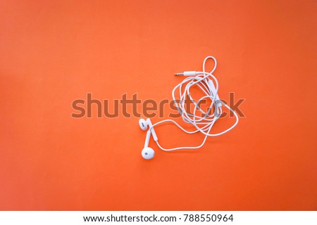 Earphones for Smartphone with Tangle Cable Line on Orange Background