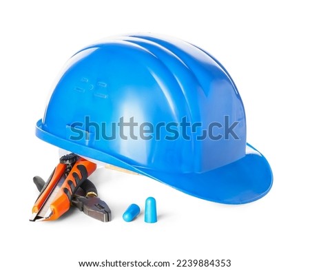 Earplugs, pliers, knife and hardhat on white background