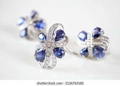 earring and ring set with big blue tanzanite and white diamonds around, jewerly shop, pawnshop concept, closeup