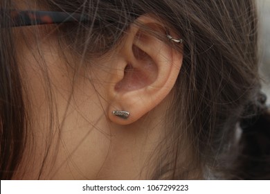 Earring Stud Butterfly Knife In The Ear Of The Girl With The Dark Hair