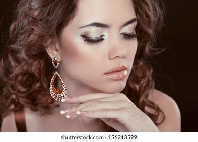 Earrings. Beauty Woman With Long Brown Curly Hair. Hairstyle. Beautiful Model Girl Portrait. Accessory