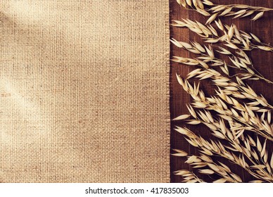 Ears Of Oat On Wooden Background