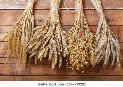 ears of wheat, rye, barley and oats on old wooden background - Shutterstock ID 1149739202