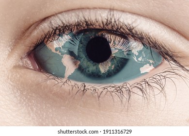 Earth continents painted on eye iris, concept save the planet. Image of earth painted on face skin. Creative composition of eye and planet earth. Elements of this image furnished by NASA .