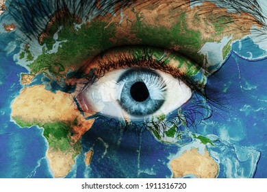 Earth continents painted on face skin, concept save the planet. Image of earth painted on face skin. Creative composition of eye and planet earth. Elements of this image furnished by NASA .