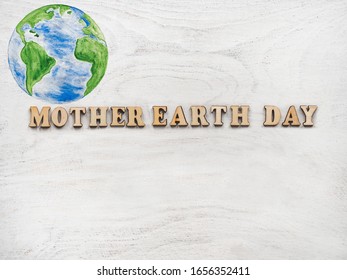 Earth Day  Beautiful greeting card  Isolated background  close  up  view from above  wooden surface  Congratulations for relatives  friends   colleagues