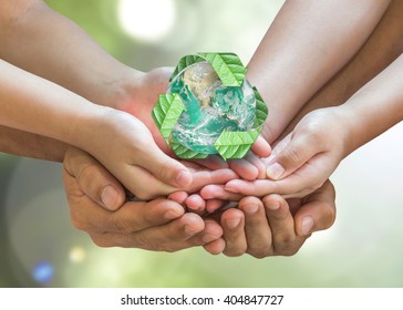 Earth Day And Ecology Concept With Family's Hands Volunteering Saving Planet With Green Global Recycle Sign For Environmental Eco-friendly, CSR, ESG Policy. Elements Of This Image Furnished By NASA