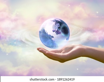 Earth Day Or Environment Day Concept. Clean Air, World Ozone Day Theme. Blue Globe In Human Hand On Cloudy Sky Background. Saving Planet, Save, Protect Green Nature And Ecology, Sustainable Lifestyle.