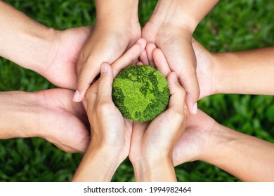 Earth Day. Hands Adult Teamwork Harmony  Holding Earth On Hands. Environmental And Reduce Global Warming Help Earth, Top View. Ecology And Environment Sustainable Concept.
