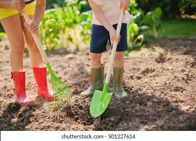 Earth Day:Low Section Two Kids Planting In The Orchard