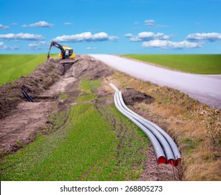 Earth Digger Used To Dig Down Cables For Broadband Connection In Rural Area