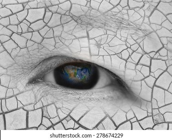 The earth in eldery women eye with dry cracked land background,earth globe in woman's eye, safe the world concept, global warming concept ,including elements furnished by NASA