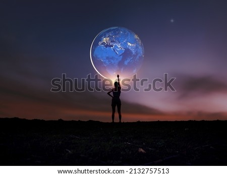 Earth in girl's hands. World Day. Energy saving, world peace,
Girl Power. Elements of this image furnished by NASA.