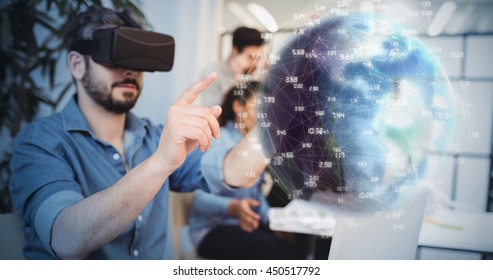 Earth globe against businessman gesturing while using virtual reality headset - Powered by Shutterstock