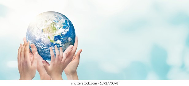 Earth globe in family hands. World environment day concept. Elements of this image furnished by NASA
