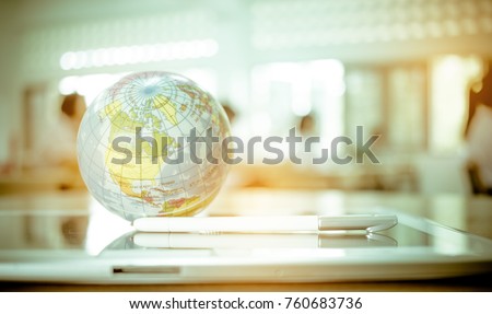 Earth globe model ball map with class room background on tablet in classroom. Concept for global international educaiton or communications, politics environmental for learning world wide. vintage tone