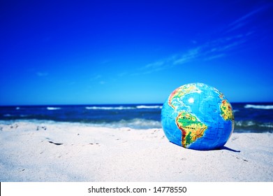 Earth Globe On The Beach. Ideal For Earth Protection Concepts, Recycling, World Issues, Enviroment Themes