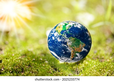 Earth Globe On Moss In A Forest With Copy Space. Earth Day, Wolrd Environment Day, Eco Friendly And Sustainable Concept, Elements Of This Image Furnished By NASA