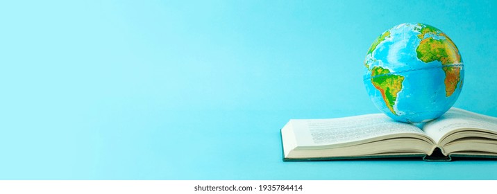 Earth Globe On An Open Book On A Blue Banner Background. Knowledge, Learning, Study Concept. Backagrund Education