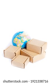 Earth Globe Is Surrounded By Boxes Isolated On White Background. Global Business And International Transportation Of Goods Products. Shipping Freight, World Trade And Economics. 