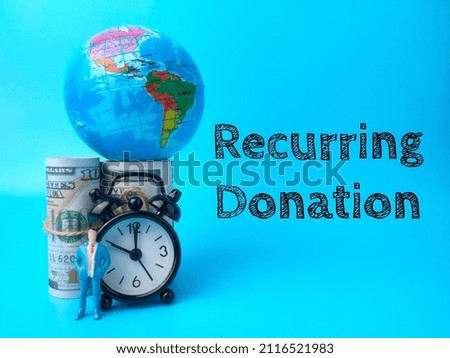 Earth globe,banknotes,miniature people and clock with text Recurring Donation on blue background.