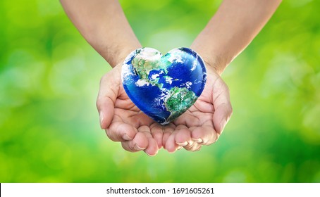  Earth Heart in Hands on Green Blurred Nature background, World Environment Day and Give Love to Our  World Concept, Elements of this image furnished by NASA