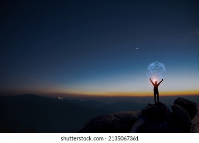Earth in human hands. earth day. energy saving, Man raise hand up on top of mountain with sunrise sky and blue sky background, freedom travel adventure and feel good concept. - Shutterstock ID 2135067361