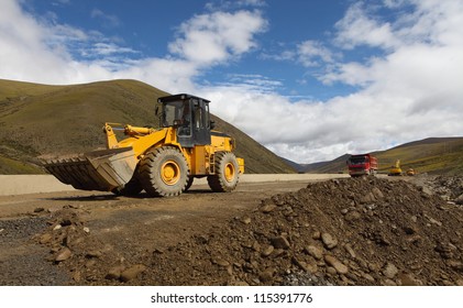 Earth Movers In Field With Dust