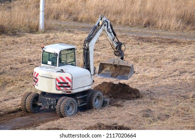 Earth Moving Tractor Preparing Place For Future House Foundation Construction. Leveling Soil For Building New Home