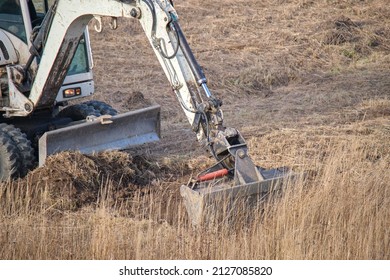 Earth Moving Tractor Preparing Place For Future House Foundation Construction. Leveling Soil For Building New Home