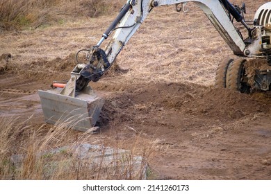 Earth Moving Tractor Preparing Place For Future House Foundation Construction. Leveling Soil For Building New Home