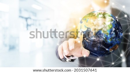 Earth at night was holding in human hands. Earth day. Energy saving concept. Businessman touching global network and data exchanges over the world. 
